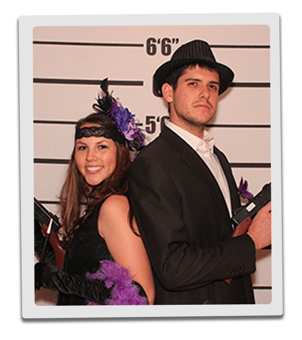 Detroit Murder Mystery party guests pose for mugshots